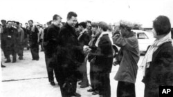 In this undated photo provided by Documentation Center of Cambodia, the late Khmer Rouge leader Pol Pot, center, greets Khmer Rouge cadre in Phnom Penh airport, Cambodia. 