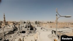 FILE - Damaged buildings are pictured during the fighting with Islamic State's fighters in the old city of Raqqa, Syria, Aug. 19, 2017. 