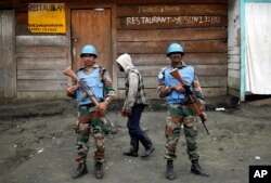 FILE - Two MONUSCO UN soldiers stand guard in Goma's port.