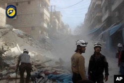 Aleppo" In this picture provided by the Syrian Civil Defense group known as the White Helmets, Syrian Civil Defense workers search through the rubble in rebel-held eastern Aleppo, Syria, Wednesday, Oct. 12, 2016.