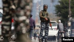 Indian Central Reserve Police Force personnel stand guard on a street in Srinagar, October 12, 2021. 