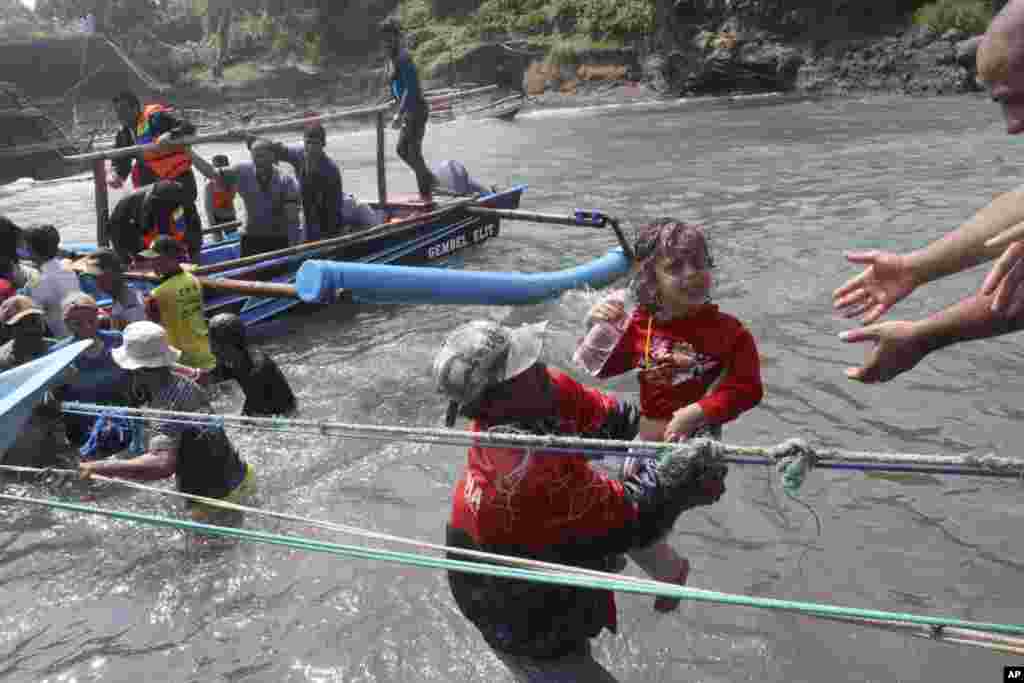 A rescuer carries a child after a boat carrying asylum seekers sank off West Java, Indonesia, July 24, 2013.&nbsp;