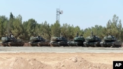 FILE - Turkish tanks stationed near the Syrian border, Sept. 3, 2016. Turkey's state-run news agency says Turkish tanks have entered Syria's Cobanbey district northeast of Aleppo in a "new phase" of the Euphrates Shield operation.