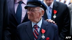 FILE - Benjamin B. Ferencz pose for a picture after he received the Legion of Honor Insignia from French minister of Defense Jean-Yves Le Drian during an awards ceremony to honor World War II veterans in New York, July 3, 2015.