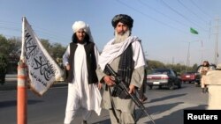 A Taliban fighter holding an M16 assault rifle stands outside the Interior Ministry in Kabul on August 16, 2021. (Reuters)