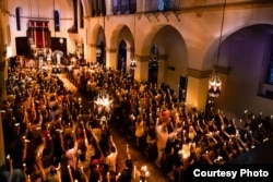 Students meet for a special event inside the Knowles Memorial Chapel at Rollins College in Winter Park, Florida.