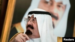 FILE - Saudi King Abdullah bin Abdul Aziz al-Saud sits before a meeting with U.S. Secretary of State John Kerry at the Royal Palace, Jeddah, Sept. 11, 2014.