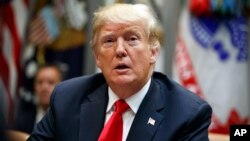 President Donald Trump listens to a reporter's question during a meeting of the President's National Council of the American Worker in the Roosevelt Room of the White House, Sept. 17, 2018, in Washington.