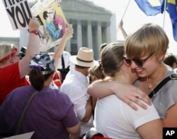 American University students Sharon Burk, left, and Molly Wagner, embrace outside the Supreme Court in Washington, June 26, 2013.