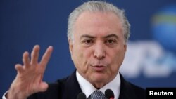 Brazil's President Michel Temer gestures during the launch of the new financing line of Bank Caixa Economica Federal at the Planalto Palace in Brasilia, Brazil, Nov. 24, 2016. 