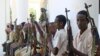 FILE- Armed men from the al-Shabab militant group are paraded at the presidential palace in Mogadishu, Somalia, after defecting from the al-Qaida-linked group to join government forces, Oct. 13, 2009.