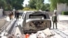 A destroyed vehicle is parked in front of Iraqi Prime Minister Mustafa al-Kadhimi's residence following an assassination attempt by an armed drone in Baghdad, Iraq in this screen grab taken from a handout video, Nov. 7, 2021.