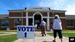 Voters arrive to cast their ballots during the Alabama Primary election at Huntingdon College in Montgomery, Ala., June 5, 2018. 