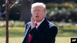 President Donald Trump yells to reporters as he walks to board Marine One on the South Lawn of the White House, Nov. 29, 2017, in Washington. 