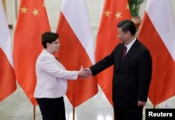 Poland's Prime Minister Beata Szydlo, left, meets China's President Xi Jinping ahead of the upcoming Belt and Road Forum at the Great Hall of the People in Beijing, May 12, 2017.