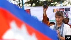 U.N. Special Rapporteur on Human Rights in Cambodia, Rhona Smith, delivers a speech to mark May Day at Tonle Sap river bank in Phnom Penh, Cambodia, Wednesday, May 1, 2019. Some hundreds of workers staged a rally, demanding a better working condition. (AP Photo/Heng Sinith)