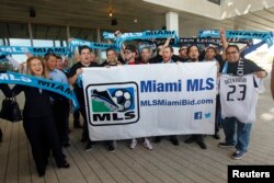Supporters of an MLS expansion team to Miami cheer as they wait for David Beckham's arrival to a news conference in Miami, Florida, Feb. 5, 2014