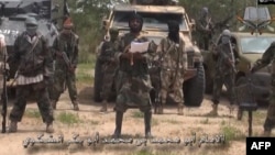 A screengrab taken on July 13, 2014 from a video released by the Nigerian Islamist extremist group Boko Haram and obtained by AFP shows the leader of the Nigerian Islamist extremist group Boko Haram, Abubakar Shekau (C). 