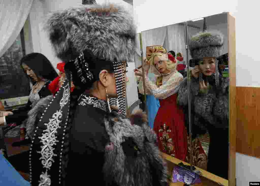 Oyuna Batuyeva, right, 23, of Buryatia and Anna Schelukhina, 20, of Krasnoyarsk region, prepare backstage before the final show of the 8th Miss Asia-Siberia international amateur beauty and talents contest in Krasnoyarsk, Russia. 