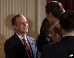 FILE - White House Chief of Staff Reince Priebus talks with White House senior adviser Jared Kushner in the East Room of the White House in Washington, July 26, 2017.