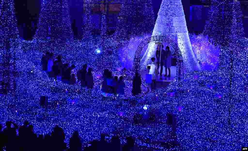 People admire illuminations featuring the theme of &quot;Canyon d&#39;Azur&quot; (Blue Canyon) at Caretta Illumination in Tokyo, Japan.