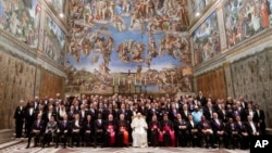 Pope Francis poses for a family photo with diplomats accredited to the Holy See inside the Sistine Chapel, at the end of an audience for the traditional exchange of New Year greetings, at the Vatican, Jan. 8, 2018. 