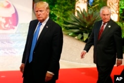 FILE - President Donald Trump, followed by Secretary of State Rex Tillerson, is pictured in Manila, Philippines, site of an ASEAN summit, Nov. 14, 2017.