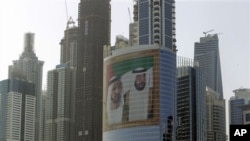 A giant image of Sheik Mohammed bin Rashid Al-Maktoum, UAE prime minister and ruler of Dubai, left, and Sheik Khalifa bin Zayed Al-Nahyan, UAE president, right, adorns a tower at Internet City on Sheikh Zayed highway in Dubai, March 9, 2011