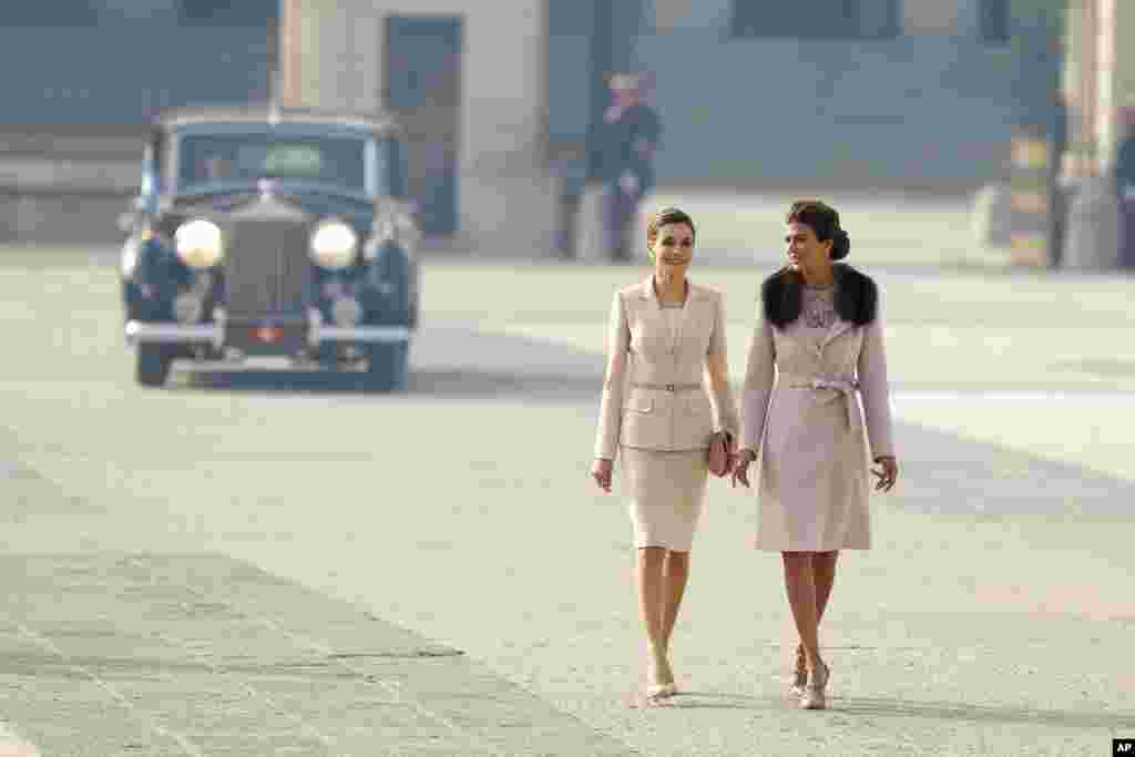 Spain's Queen Letizia, left, walks with Juliana Awada, the wife of Argentina's President Mauricio Macri, during a welcome ceremony at the Royal Palace in Madrid.