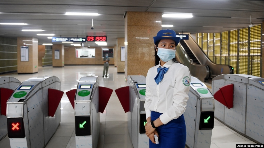 An attendant stands near turnstiles at Lang station in Hanoi, Vietnam, Nov. 6, 2021, on opening day of the city's first urban metro train running along the Cat Linh-Ha Dong line. (Photo by Nhac NGUYEN / AFP)
