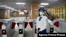 FILE - An attendant stands near turnstiles at Lang station in Hanoi, Vietnam, Nov. 6, 2021, on opening day of the city's first urban metro train running along the Cat Linh-Ha Dong line. Rides were free during a 15-day trial period.