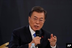 South Korean President Moon Jae-in answers reporters' question during his New Year news conference at the Presidential Blue House in Seoul, South Korea, Jan. 10, 2018.