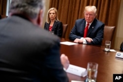 Secretary of Homeland Security Kirstjen Nielsen and President Donald Trump listen to Rep. Peter King, R-N.Y., during a meeting with law enforcement officials on the MS-13 street gang and border security, in the Cabinet Room of the White House, Feb. 6, 2018.