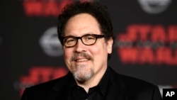 FILE - Jon Favreau arrives at the Los Angeles premiere of "Star Wars: The Last Jedi" in Los Angeles, California, Dec. 9, 2017. Favreau will write and executive produce a live-action “Star Wars” series for the Walt Disney Co.’s planned streaming platform.