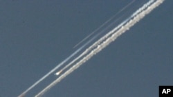 Debris from the space shuttle Columbia streaks across the Texas sky Saturday morning, Feb. 1. 2003.