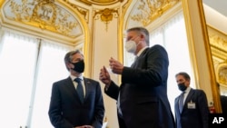 US Secretary of State Antony Blinken, left, tours an exhibit on the Marshall Plan with Secretary-General of the Organization for Economic Cooperation and Development (OECD) Mathias Cormann, of Australia, at OECD's headquarters, Oct. 5, 2021, in Paris.