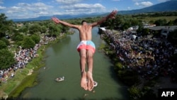 On July 19m 2020, a diver jumps from the 22-meter-high bridge "Ura e Shenjte" near the town of Gjakova. This was a sign of protest. Police cancelled the 70th traditional annual High Diving competition because of failure to follow COVID safety measures. (Photo Armend NIMANI / AFP)