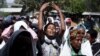 FILE - Women mourn during the funeral ceremony of Dinka Chala, a primary school teacher who family members said was shot dead by military forces during a recent demonstration, in Holonkomi town, in Oromia region of Ethiopia, Dec. 17, 2015.