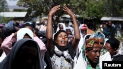 FILE - Women mourn during the funeral ceremony of Dinka Chala, a primary school teacher who family members said was shot dead by military forces during a recent demonstration, in Holonkomi town, in Oromia region of Ethiopia, Dec. 17, 2015.