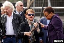 Gro Harlem Brundtland, Norway's former prime minister, joins Richard Branson and Graca Machel, widow of former President Nelson Mandela, on a walk to commemorate what would have been Mandela's 99th birthday in Cape Town, South Africa, July 18, 2017.