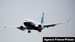 FILE - A Boeing 737 MAX airliner piloted by Federal Aviation Administration Administrator Steve Dickson lands following an evaluation flight at Boeing Field in Seattle, Sept. 30, 2020.