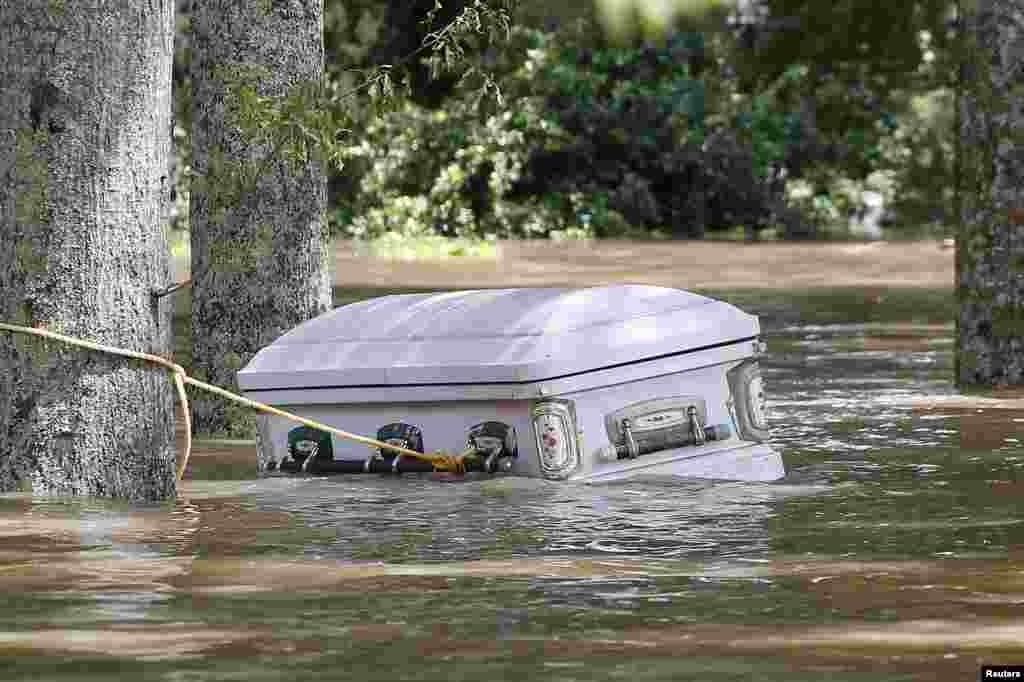 A casket is seen floating in flood waters in Ascension Parish, Louisiana.