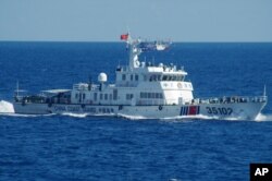 In this photo released by the 11th Regional Coast Guard Headquarters of Japan, a Chinese coast guard vessel sails near disputed East China Sea islands, Aug. 6, 2016.