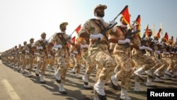 FILE - Members of the Iranian Revolutionary Guard march during a parade to commemorate the anniversary of the Iran-Iraq war (1980-88), in Tehran, Sept. 22, 2011. 