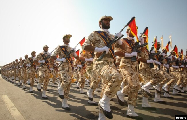 FILE - Members of the Iranian Revolutionary Guard march during a parade to commemorate the anniversary of the Iran-Iraq war (1980-88), in Tehran, Sept. 22, 2011.