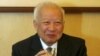 Cambodian King Norodom Sihanouk holds a glass during a meeting with Chinese State Councilor Dai Bingguo (not seen) in Beijing, October 30, 2006.