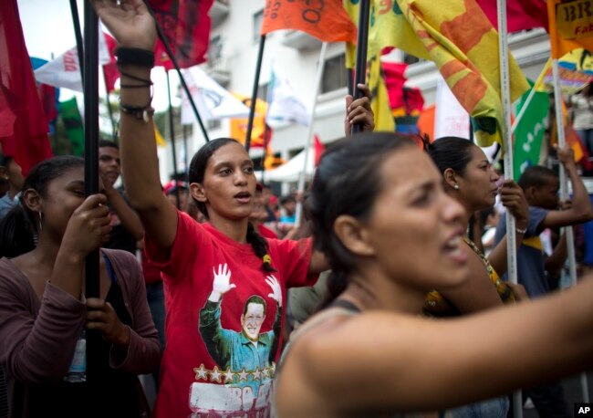 Government supporters march during an anti-imperialist rally in Caracas, Venezuela, Saturday, March 30, 2019.