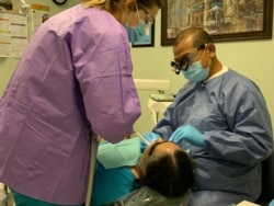 Dr. Sonny Duong, treats a patient in his dental office at the Community Health Center in Fredericksburg, VA.