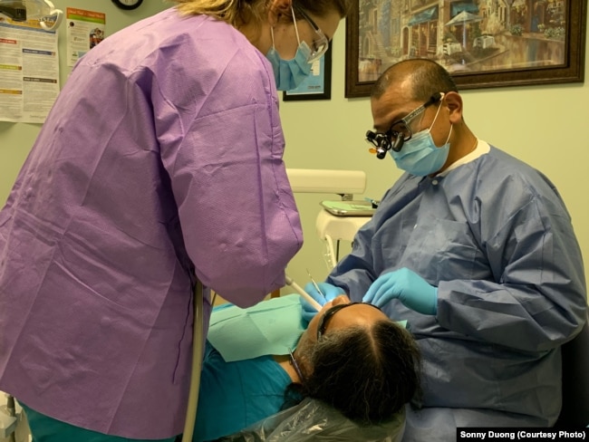 Dr. Sonny Duong, treats a patient in his dental office at the Community Health Center in Fredericksburg, VA.
