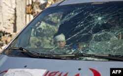A wounded boy sits inside an ambulance as Syrian rebels and their families gather at the rebel-held al-Amiriyah neighborhood as they wait to be evacuated to the government-controlled area of Ramoussa on the southern outskirts of the city on Dec. 15, 2016.